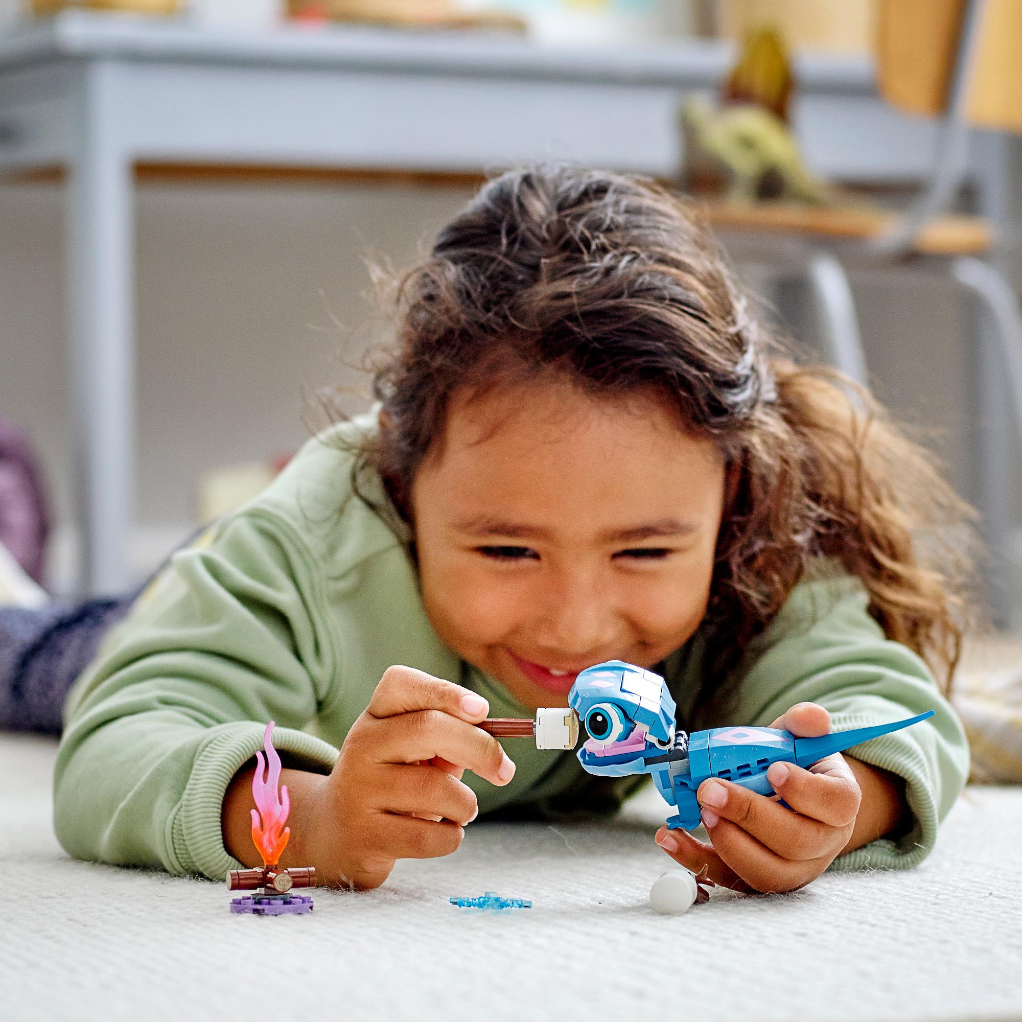Child playing with LEGO® Disney Frozen 2 Bruni salamander toy, enjoying imaginative play with colorful accessories.