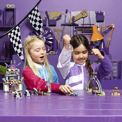 Two children excitedly play with the LEGO® Friends Heartlake The Big Race Day playset, surrounded by racing-themed decorations.
