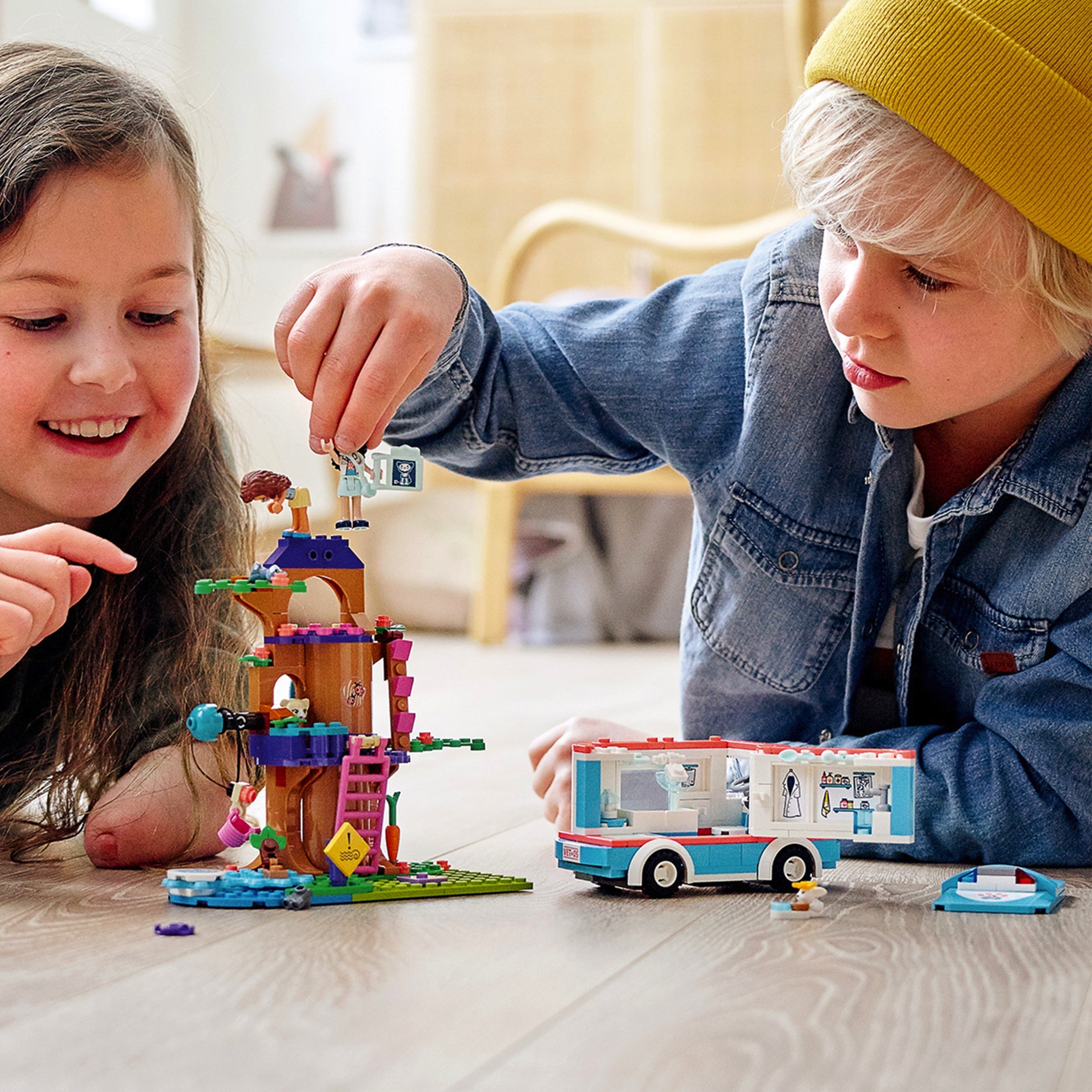 Kids playing with LEGO Friends Vet Clinic Ambulance Toy Car 41445, enjoying rescue play and teamwork.