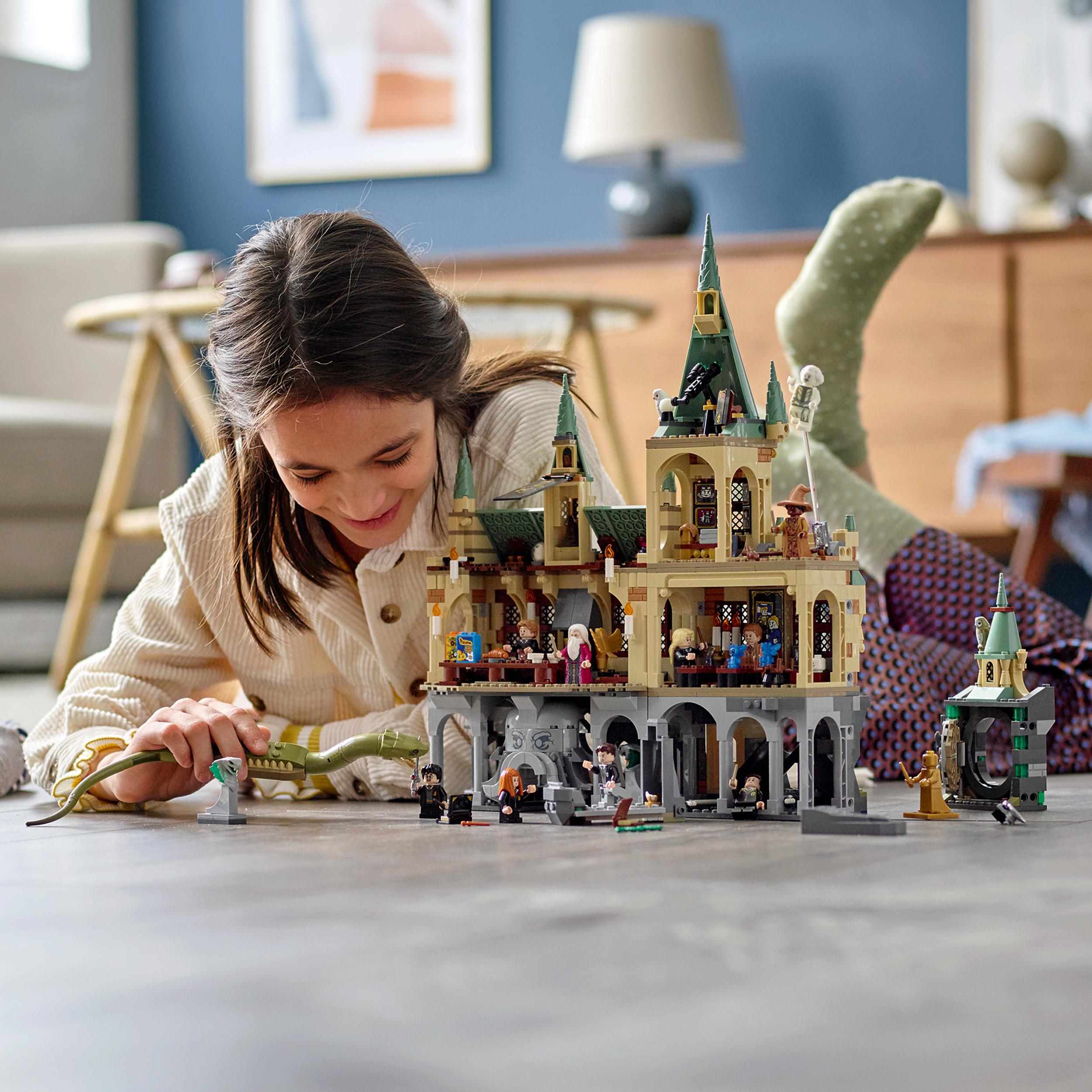 Child playing with LEGO® Harry Potter Hogwarts Chamber of Secrets set 76389, showcasing imaginative play and display.
