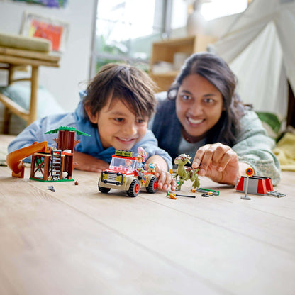 Kids playing with LEGO® Jurassic World Dinosaur Escape Toy 76939 featuring a Stygimoloch, off-roader, and tree house.