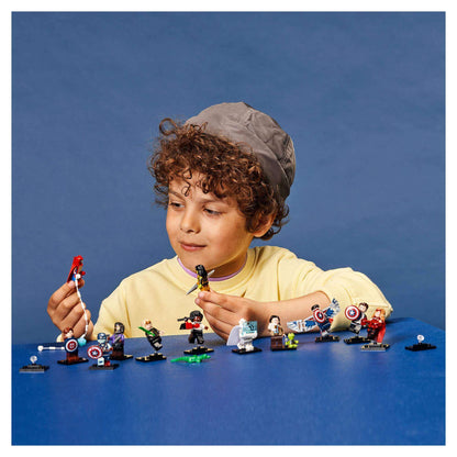 Child playing with LEGO® Minifigures Marvel Studios characters, showcasing creativity and fun with detailed accessories.