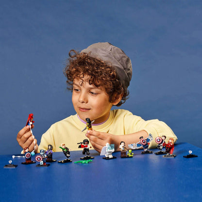 Child exploring LEGO® Minifigures from Marvel Studios Building Set 71031 with various accessories and characters.
