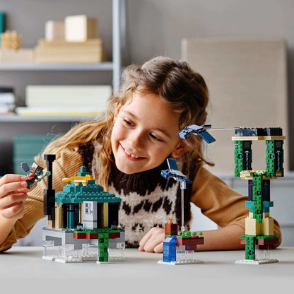Child playing with LEGO® Minecraft The Sky Tower set, showcasing creative building and imaginative play.