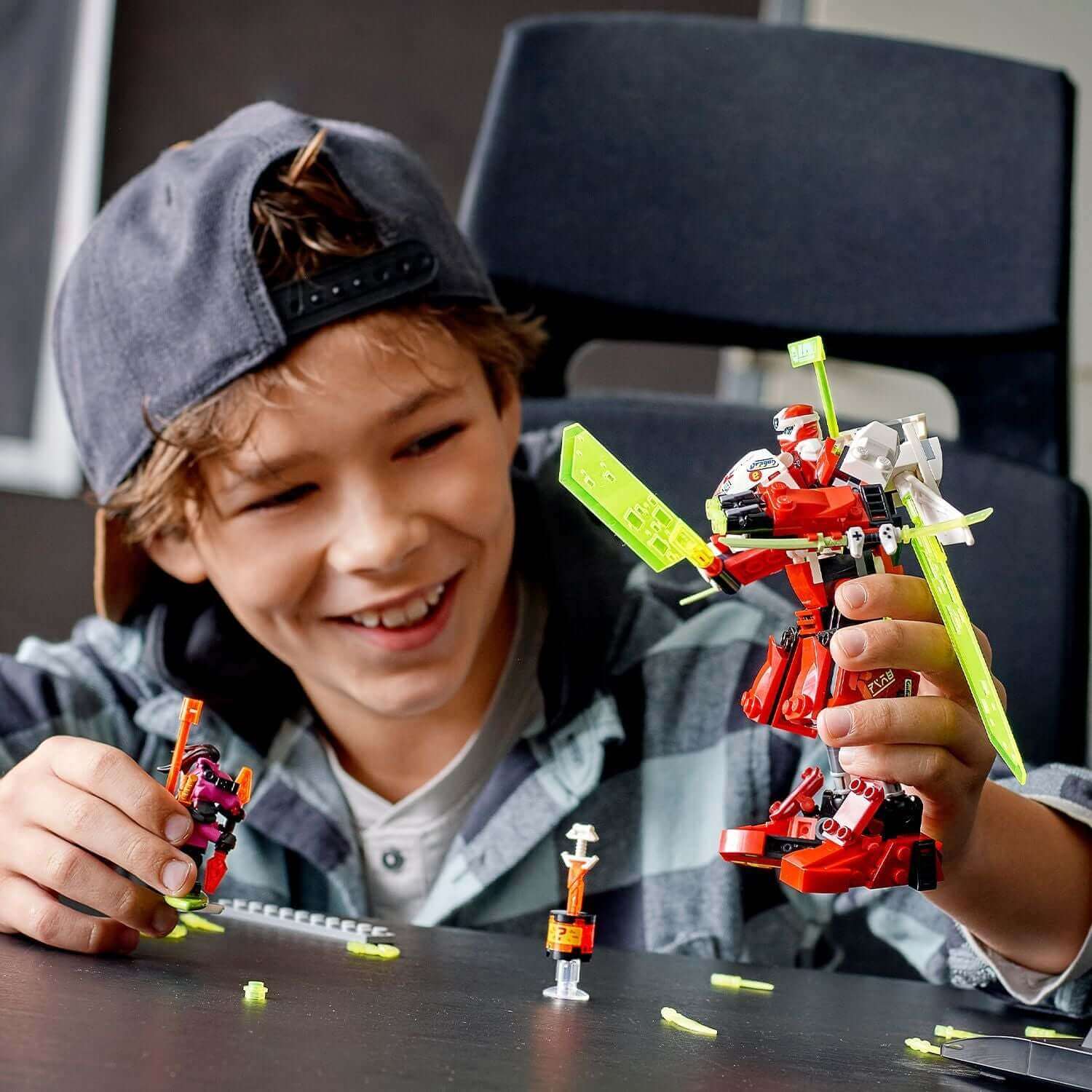Child building LEGO NINJAGO Kai's Mech Jet set 71707, showcasing creativity and play with colorful mech and jet designs.