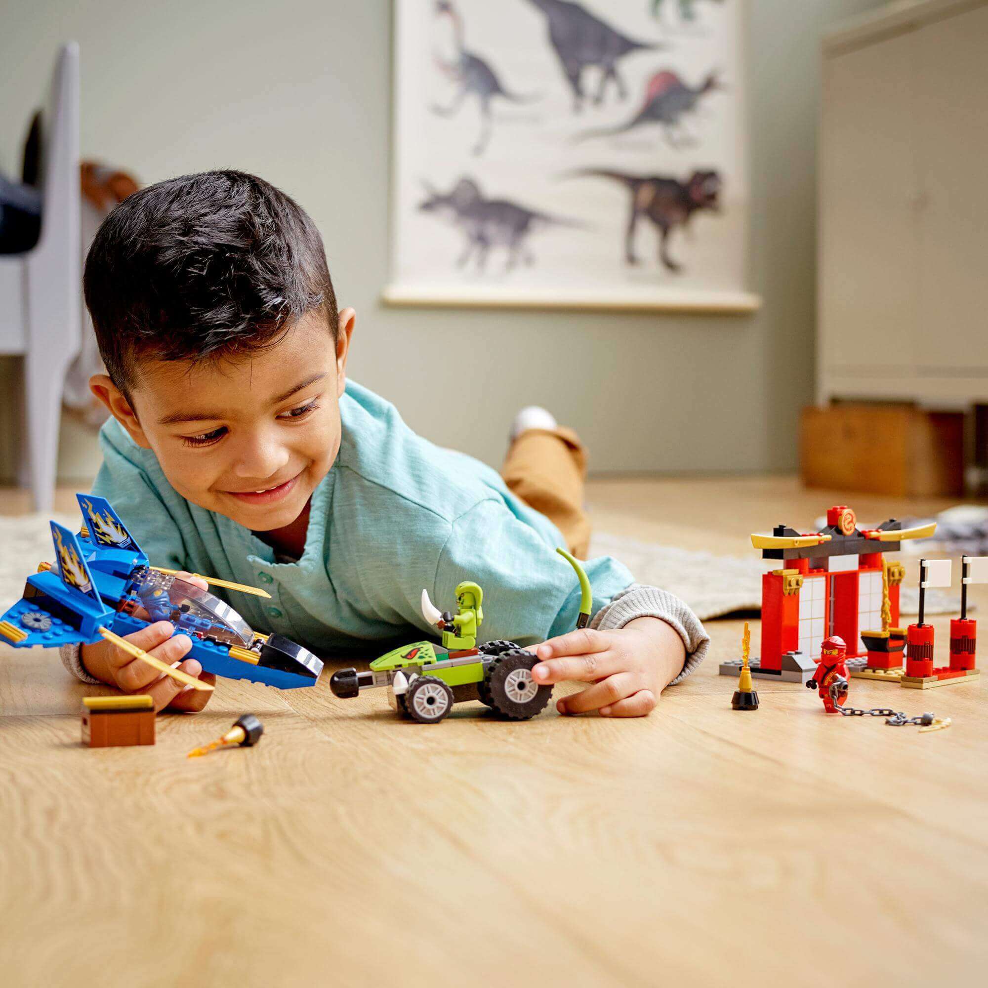 Child playing with LEGO NINJAGO Legacy Storm Fighter Battle Toy 71703, engaged in imaginative play with Kai and Jay.