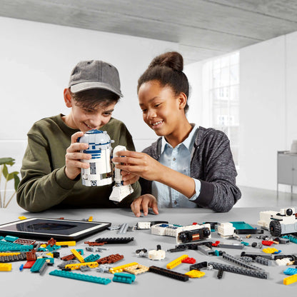 Kids building LEGO Star Wars BOOST Droid Commander with R2-D2, exploring coding with creativity and fun.