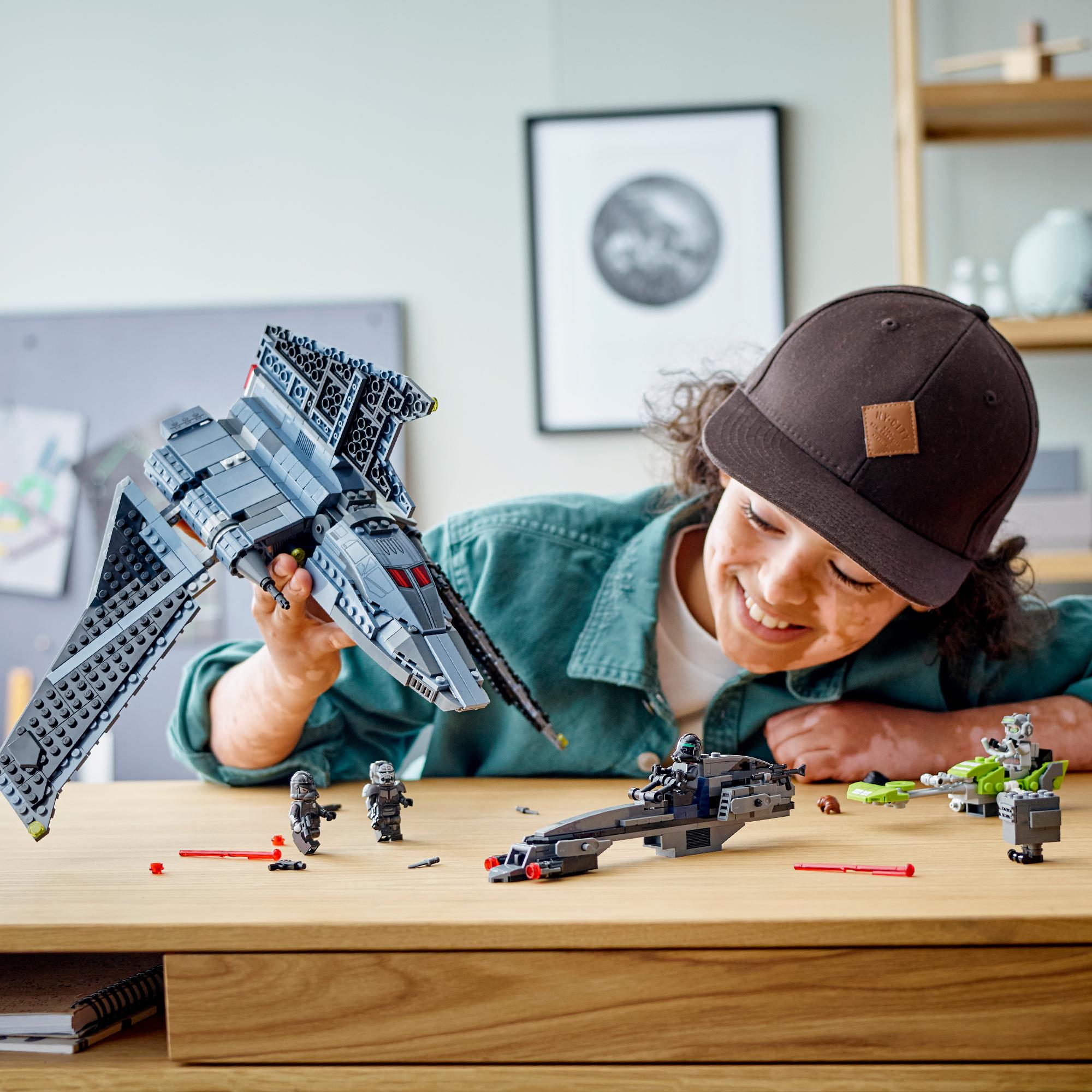 Child playing with LEGO Star Wars Bad Batch Attack Shuttle set, showcasing creativity and adventure in roleplay.