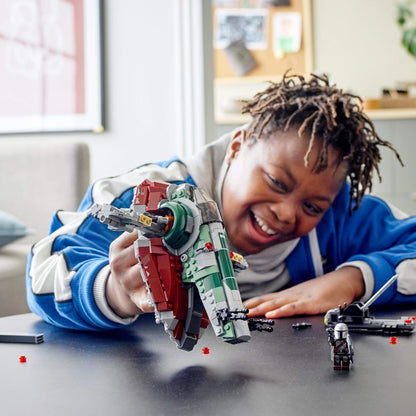 Child playing with LEGO® Star Wars Boba Fett’s Starship Set 75312, showcasing creativity and fun in a home setting.