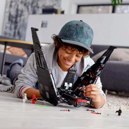 Child assembling LEGO Star Wars Kylo Ren's Shuttle set 75256, enjoying creative playtime.