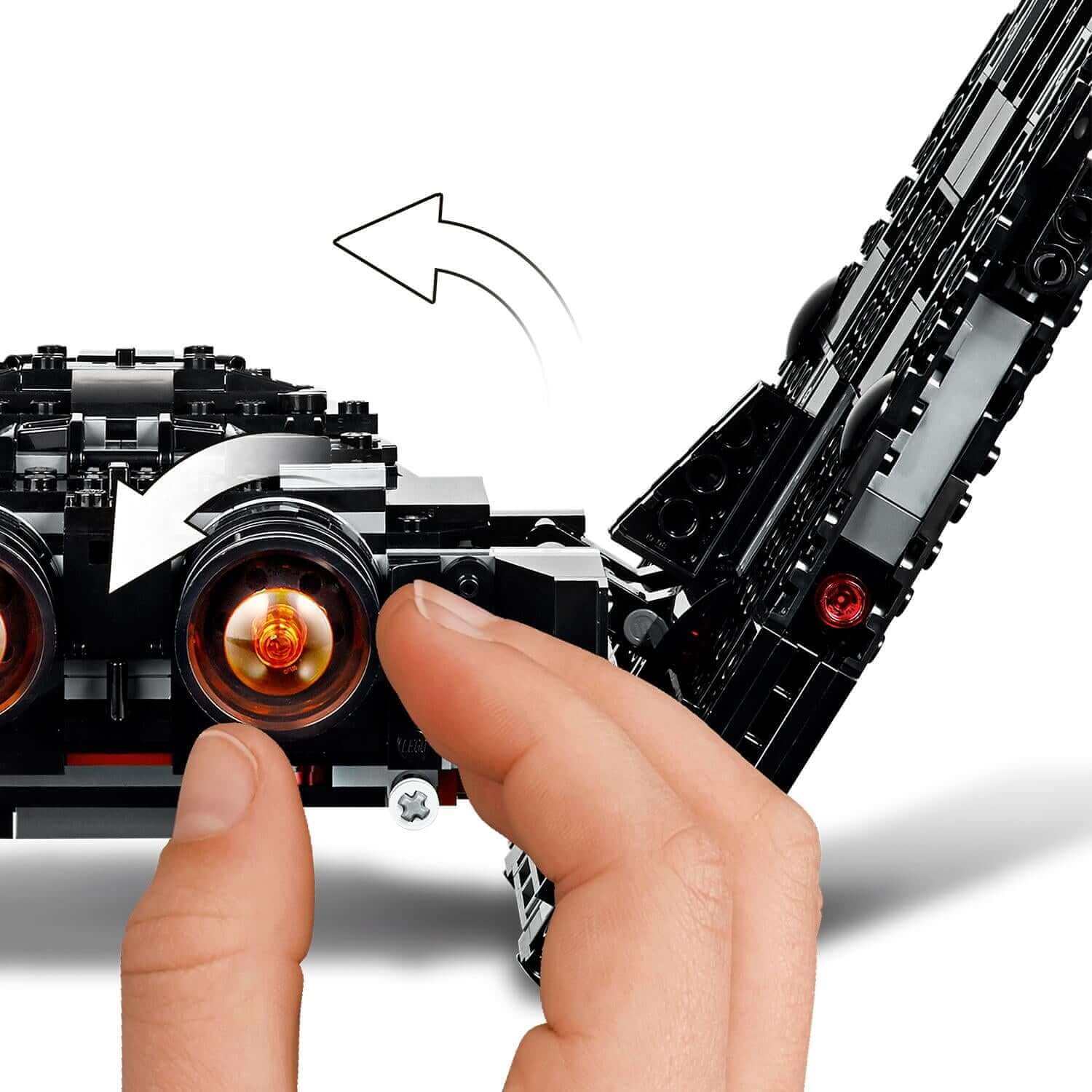 Child's hand interacting with LEGO Star Wars Kylo Ren's Shuttle, showcasing movable features and exciting design.