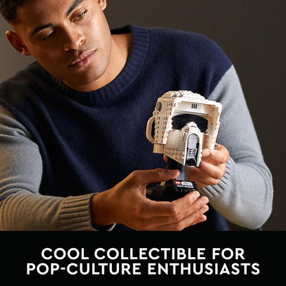 Adult man holding a LEGO Star Wars Scout Trooper Helmet collectible, perfect for pop-culture enthusiasts.