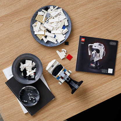 LEGO Star Wars Scout Trooper Helmet adult set 75305 with building pieces and instruction manual on a wooden table.