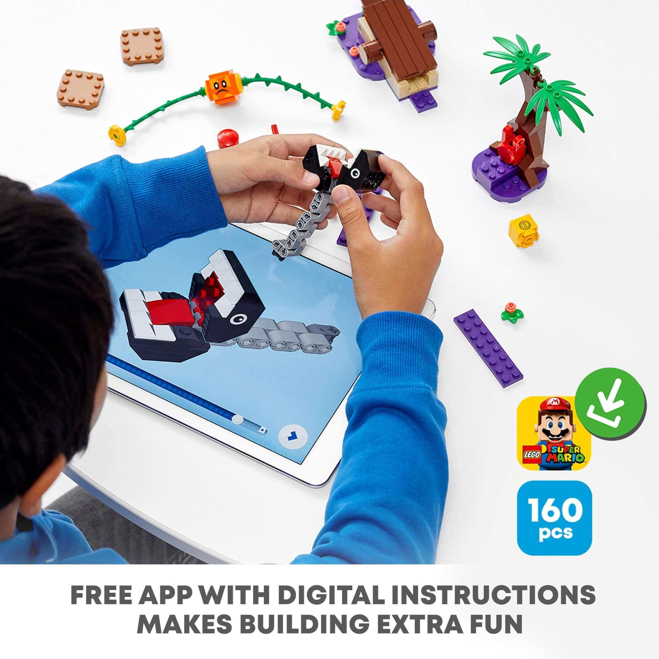 Child using a tablet with digital instructions to build LEGO® Super Mario Jungle Encounter Set 71381, featuring 160 pieces.