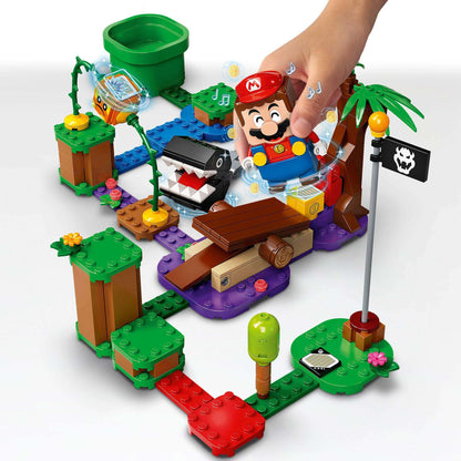 Child interacting with LEGO® Super Mario Jungle Encounter Expansion Set 71381, featuring Chain Chomp and interactive elements.