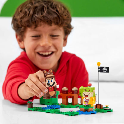 Child playing with LEGO® Super Mario Tanooki Mario Power-Up Pack 71385, engaging in interactive fun.