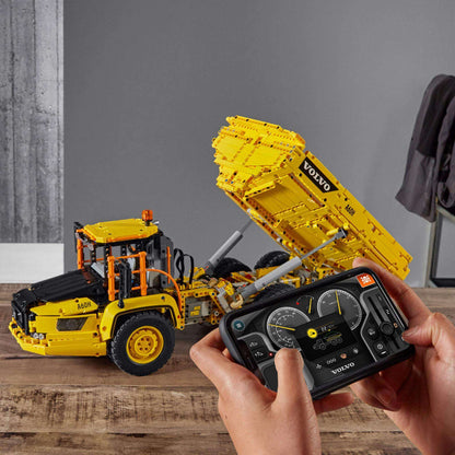 LEGO Technic 6x6 Volvo articulated hauler truck being controlled via app, showcasing creativity in construction play.
