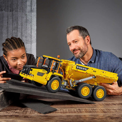 Kids enjoying creative play with the LEGO® Technic 6x6 Volvo Articulated Hauler Truck 42114 toy.