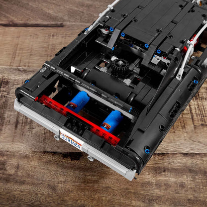 Close-up of LEGO® Technic Dom's Dodge Charger set, showcasing engine details and rear design for fast car enthusiasts.