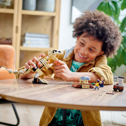 Child enjoying the LEGO® Jurassic World T. rex fossil set while playing at a table.