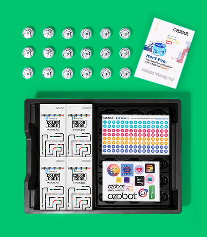 Ozobot Evo Classroom Kit 18-pack with markers, robot stickers, and instruction manual on green background.