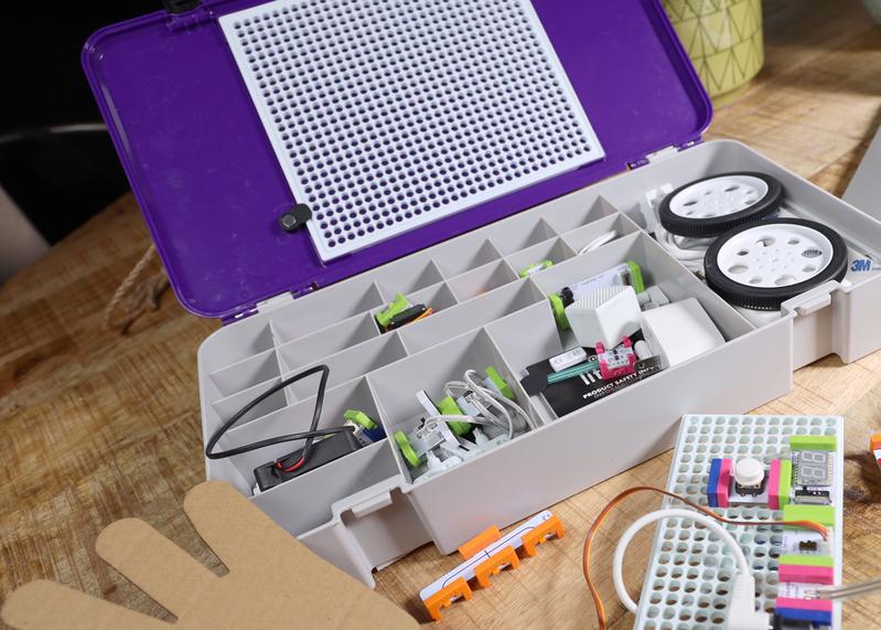LittleBits STEAM Student Set kit opened on a wooden table showcasing components for hands-on engineering projects.