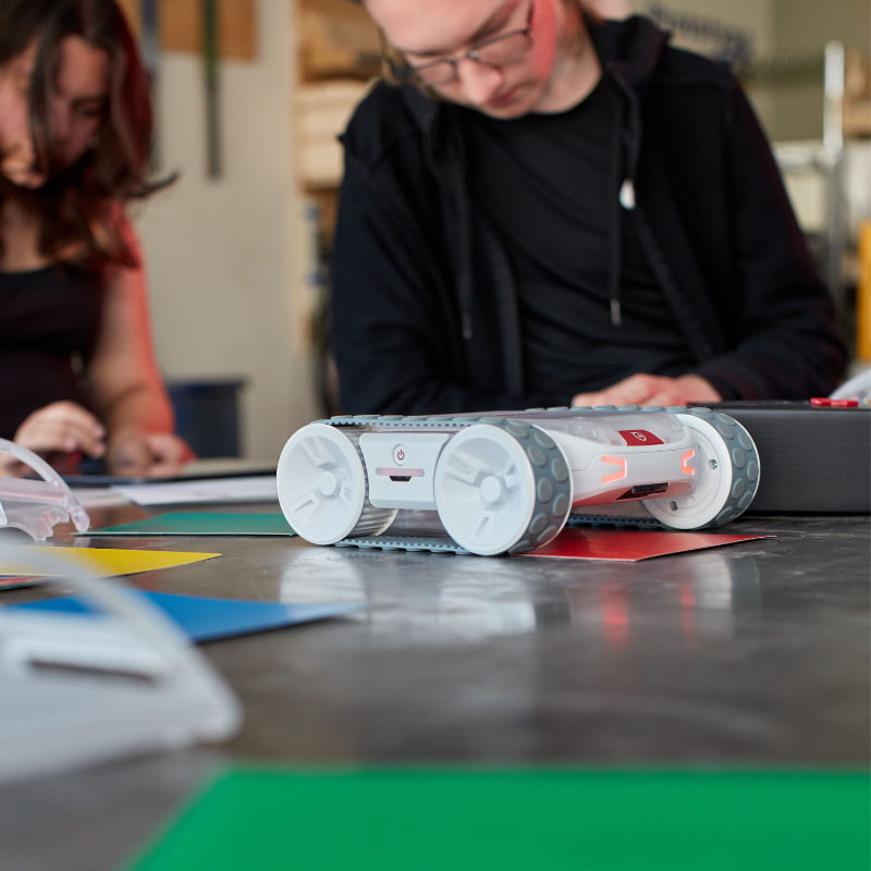 Sphero RVR+ programmable robot on a table with students engaging in coding and hands-on learning.