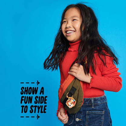 Child smiling while wearing an orange and green bag with a LEGO® DOTS bag tag, showcasing fun and style.