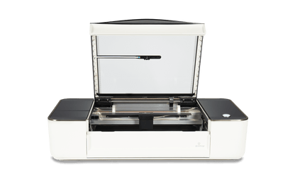 Glowforge Plus open showing laser engraving bed and upgraded components for fast, high-quality projects.