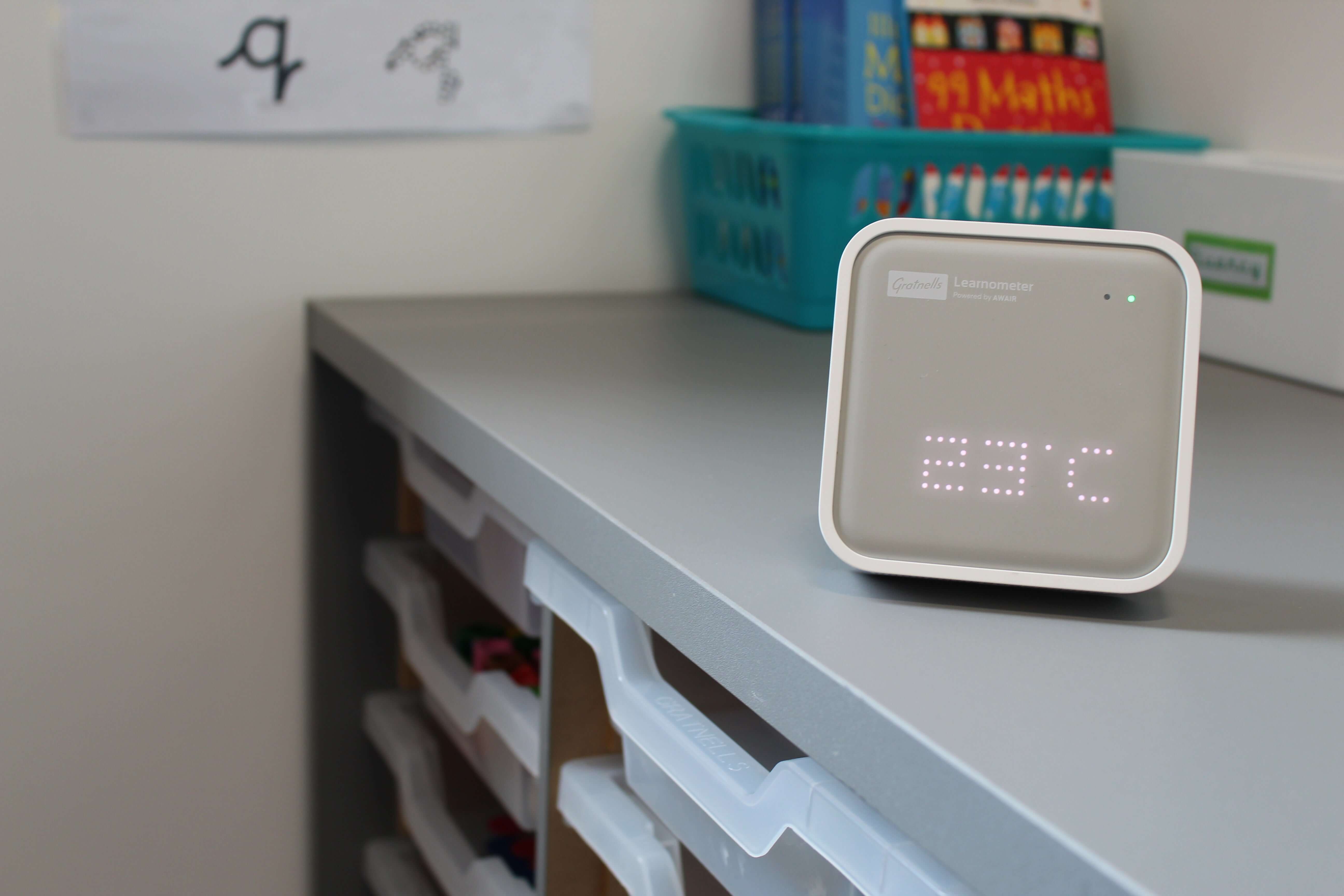Gratnells Learnometer device on a classroom desk displaying temperature for optimizing learning conditions.