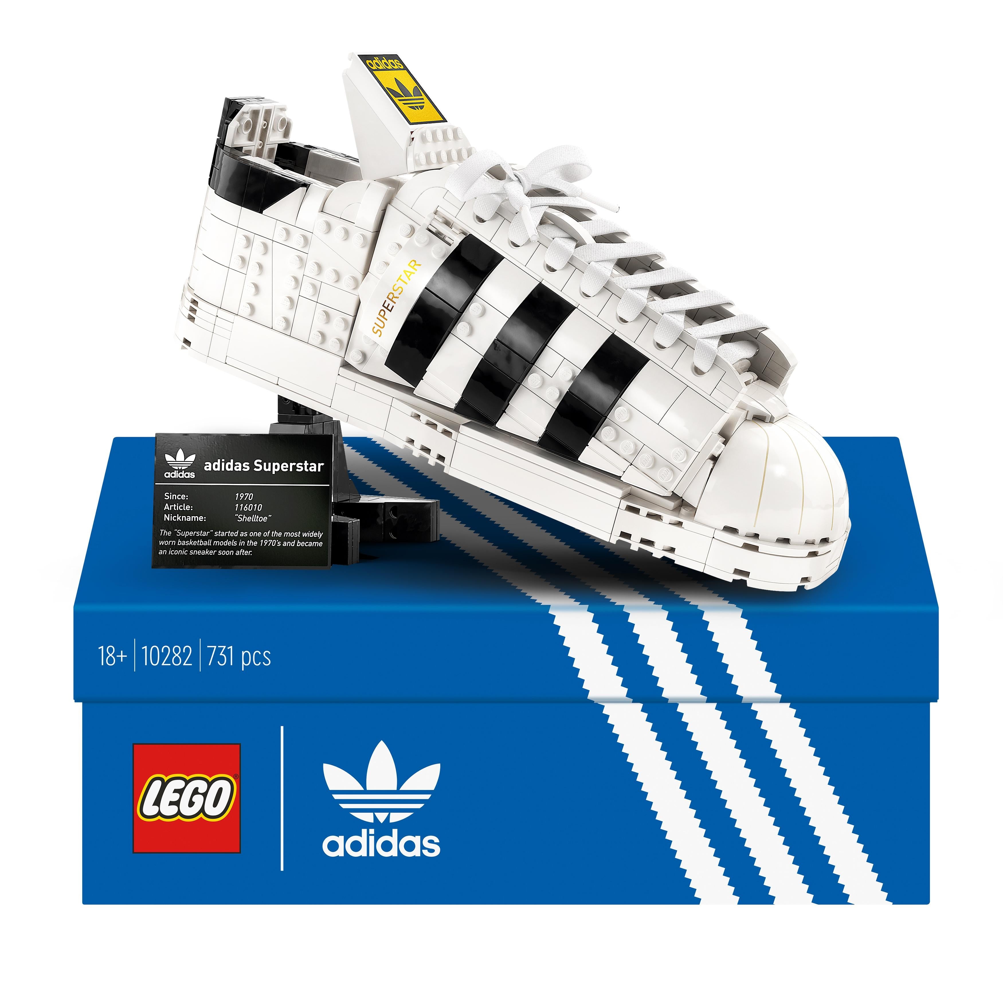 LEGO® adidas Originals Superstar Set 10282 displayed on box, showcasing detailed white shoe design with black stripes.