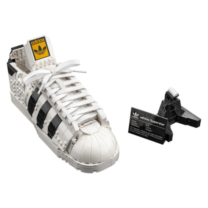 LEGO adidas Originals Superstar Set 10282 showing a white sneaker with black stripes and a display stand.