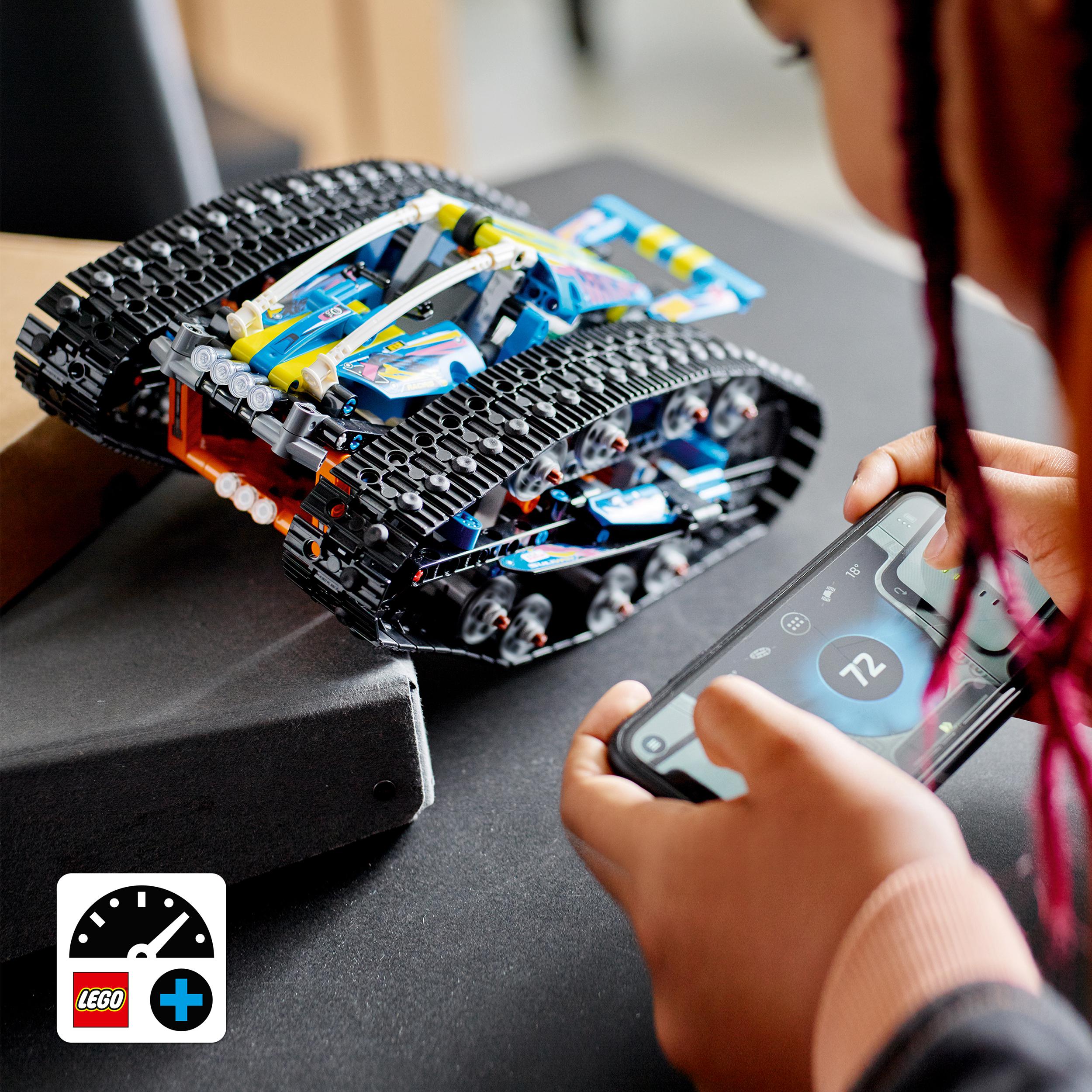 Child using a smartphone to control the LEGO App-Controlled Transformation Vehicle 42140 on a table.
