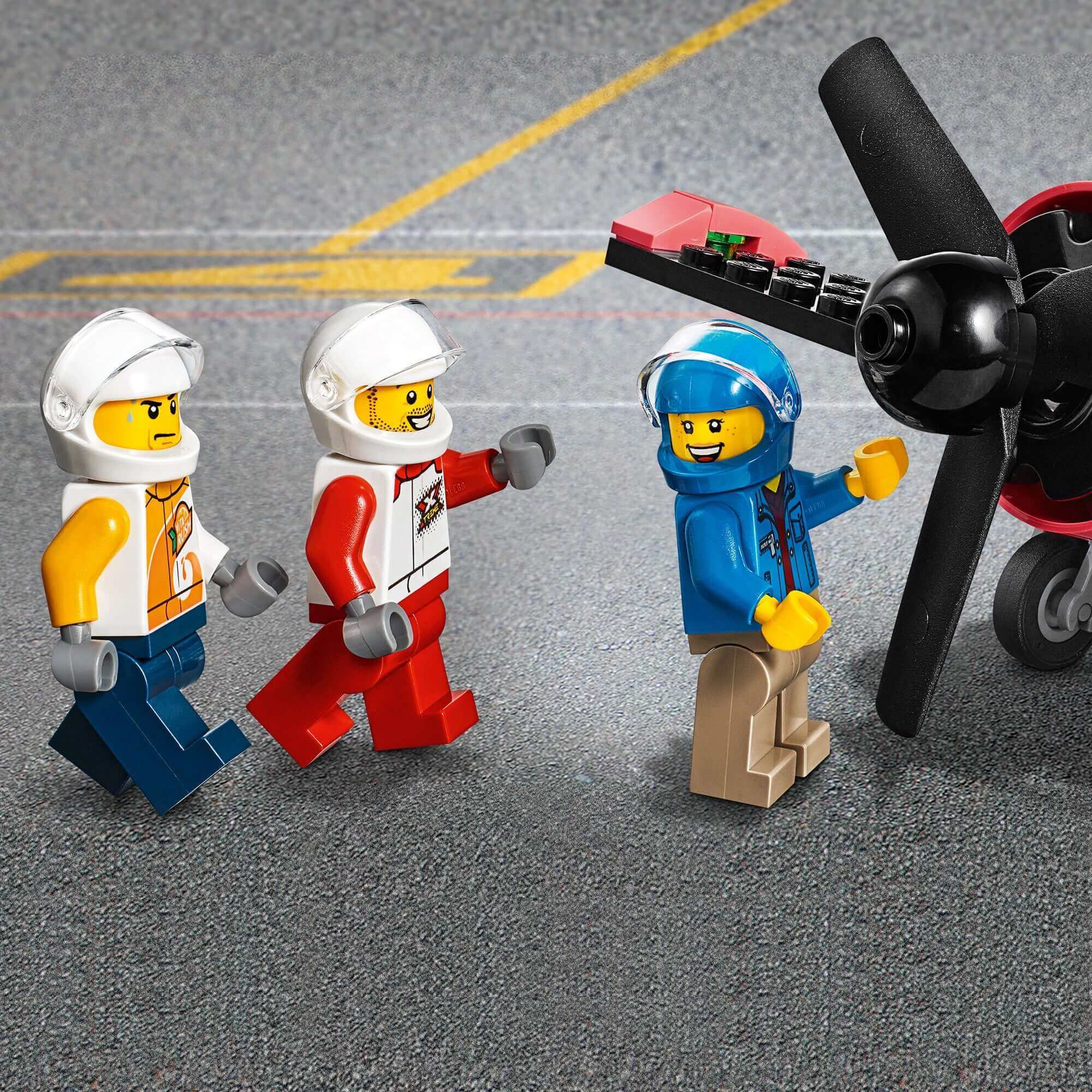 LEGO® City Airport Air Race set featuring three minifigures and a toy plane on the runway.