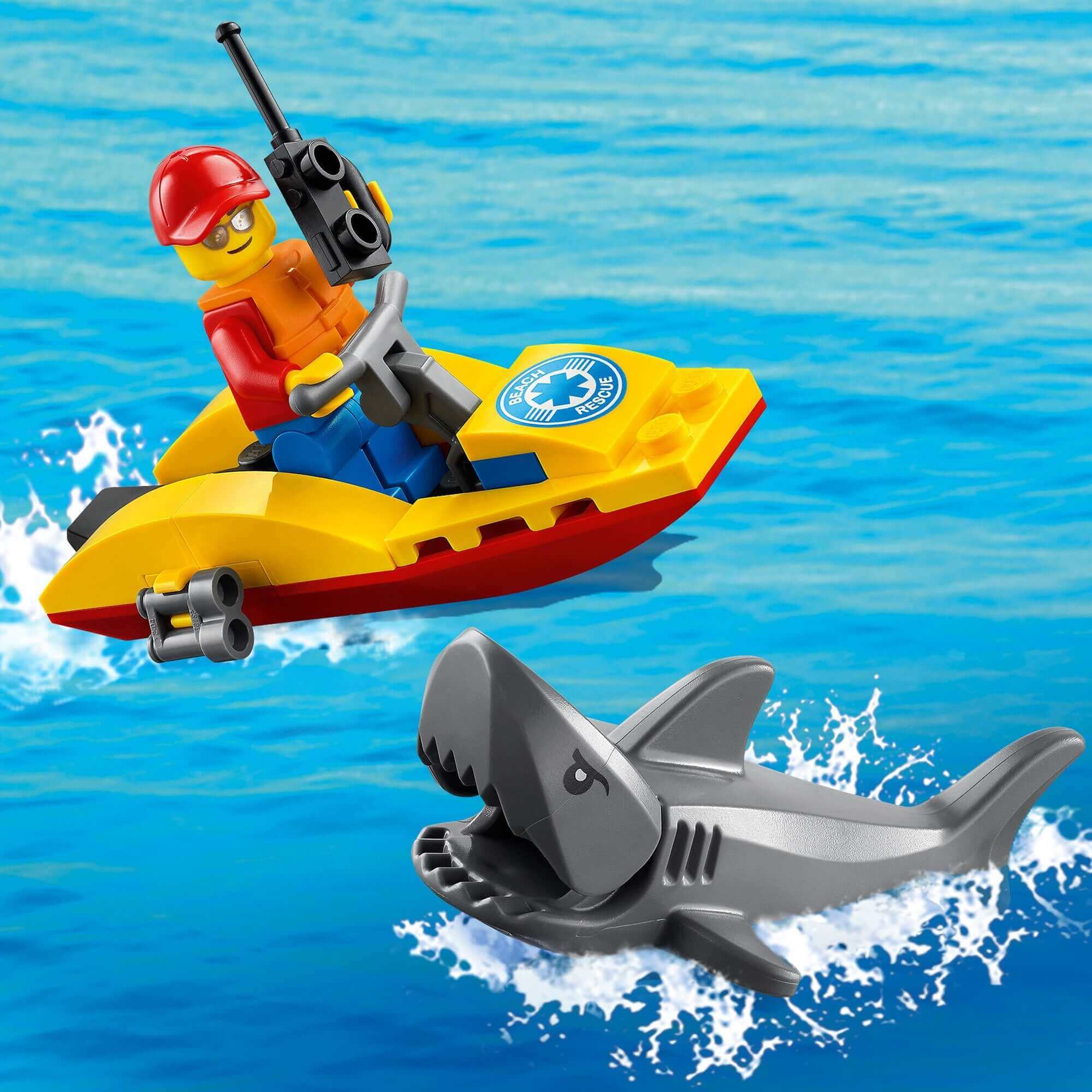 LEGO® City Beach Rescue ATV playset with lifeguard minifigure on water scooter next to a shark in the ocean.