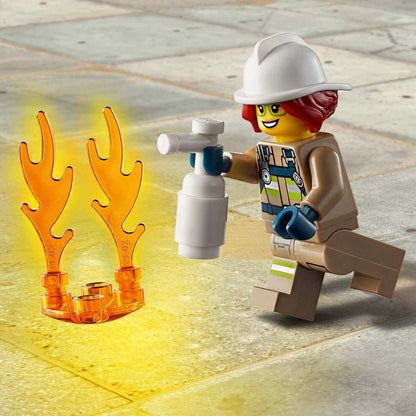LEGO® City firefighter Freya McCloud extinguishing flames with a water spray, showcasing bravery in emergency response.
