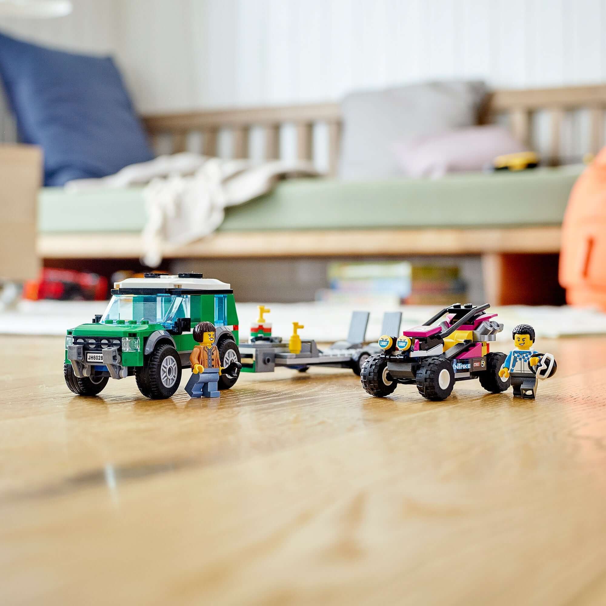 LEGO® City Race Buggy Transporter with SUV, trailer, race buggy, and 2 driver minifigures on wooden floor.