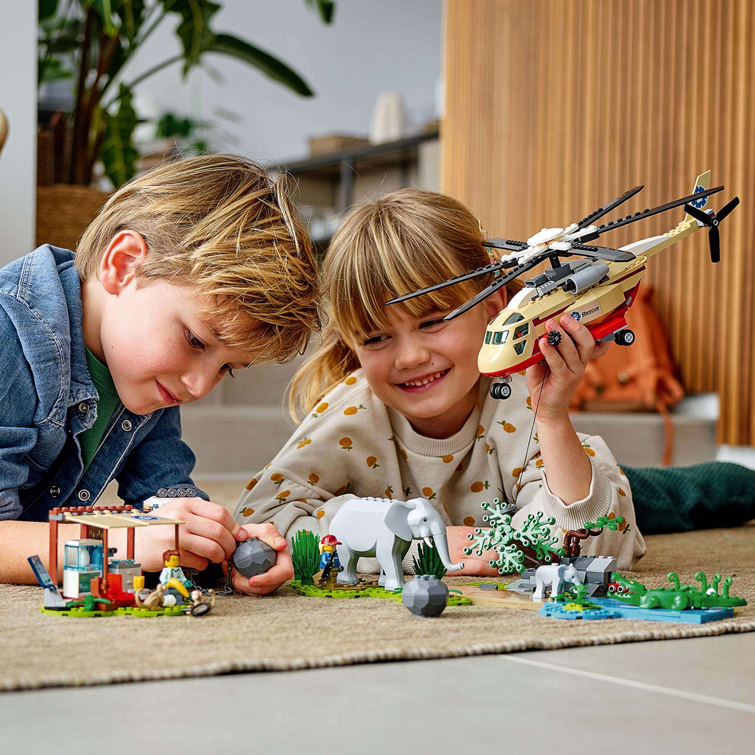 Kids enjoying the LEGO® City Wildlife Rescue Operation Vet Set 60302 with animals and a helicopter for fun roleplay.