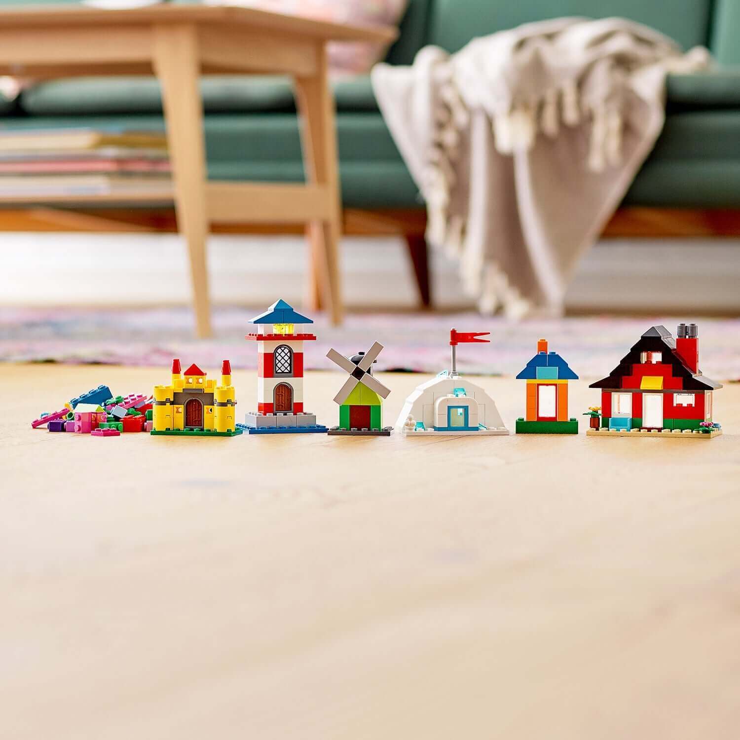LEGO® Classic 4+ Bricks and Houses Set 11008 showcasing colorful miniature houses, including a castle, lighthouse, and igloo.