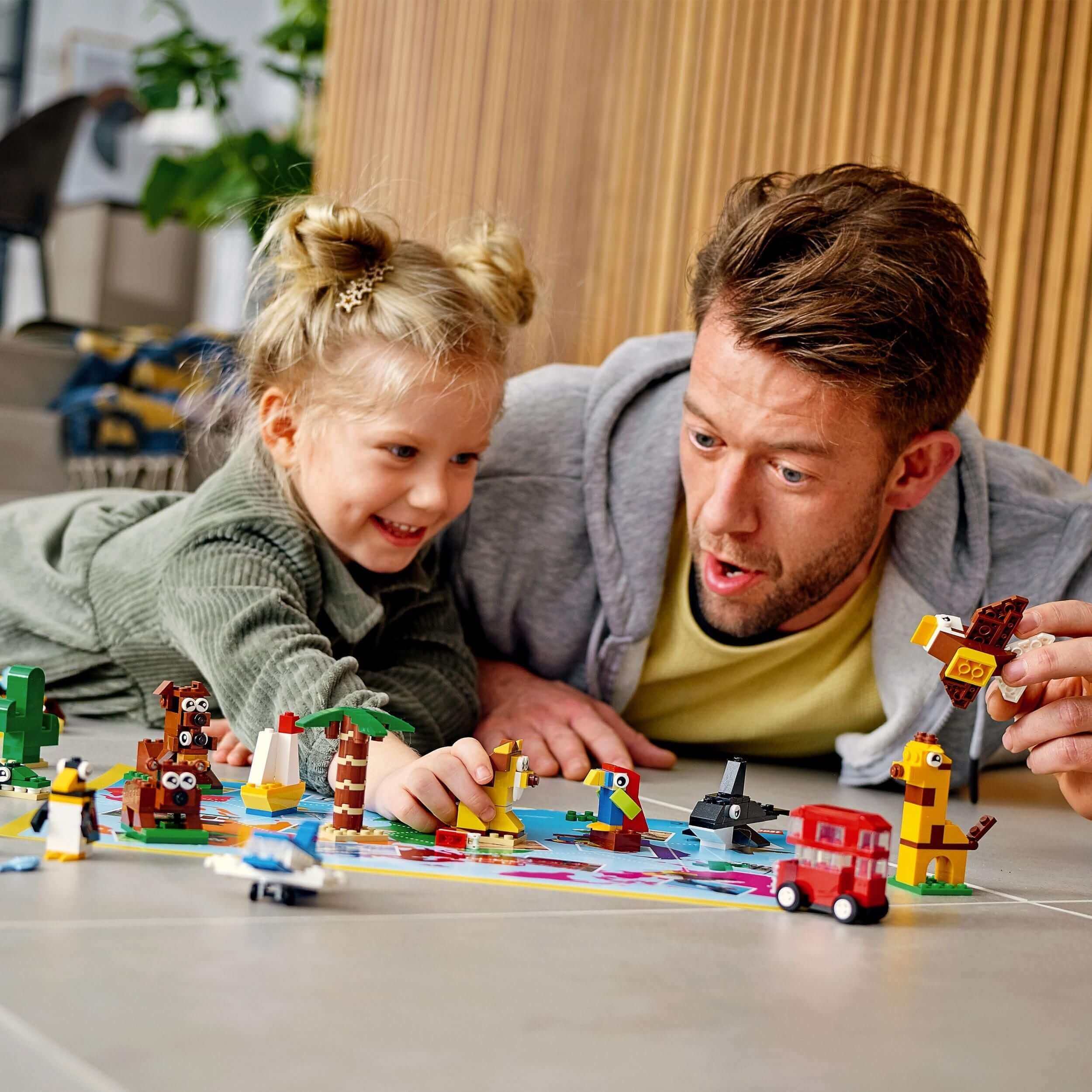 Father and daughter enjoying LEGO Classic Around the World Bricks Set 11015, exploring iconic animals and objects.