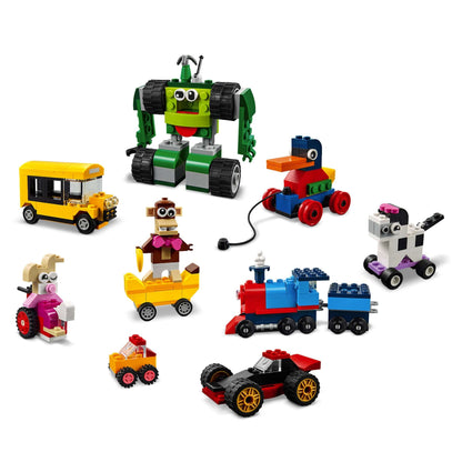 Colorful LEGO® Classic Bricks and Wheels Building Set 11014 featuring various vehicles and playful characters.