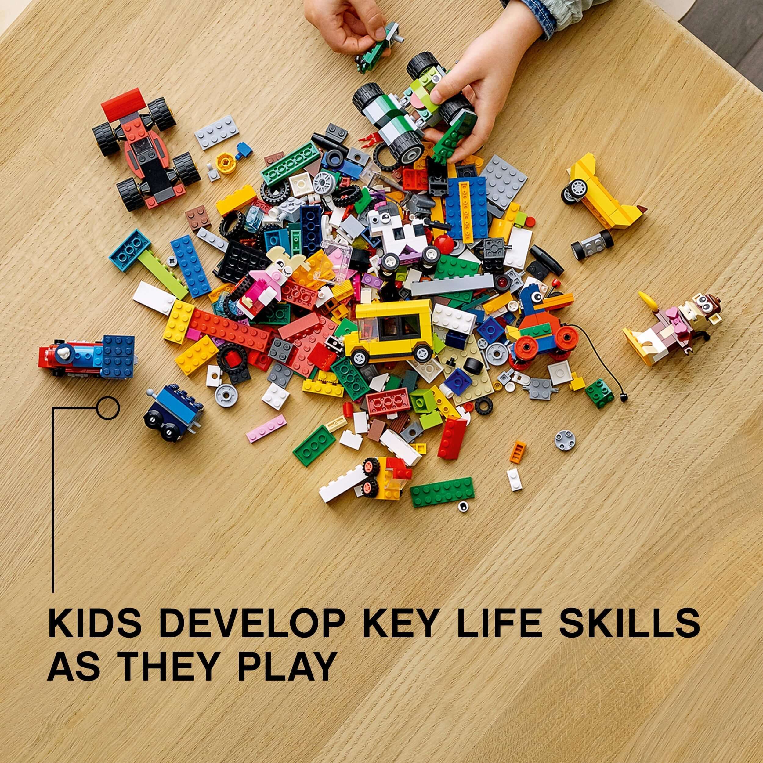 Colorful LEGO® bricks and wheels scattered on a table, inspiring creativity and key life skills in children.