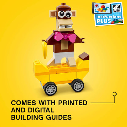 Colorful LEGO monkey figure on a yellow wheeled cart with banana, includes printed and digital building guides.