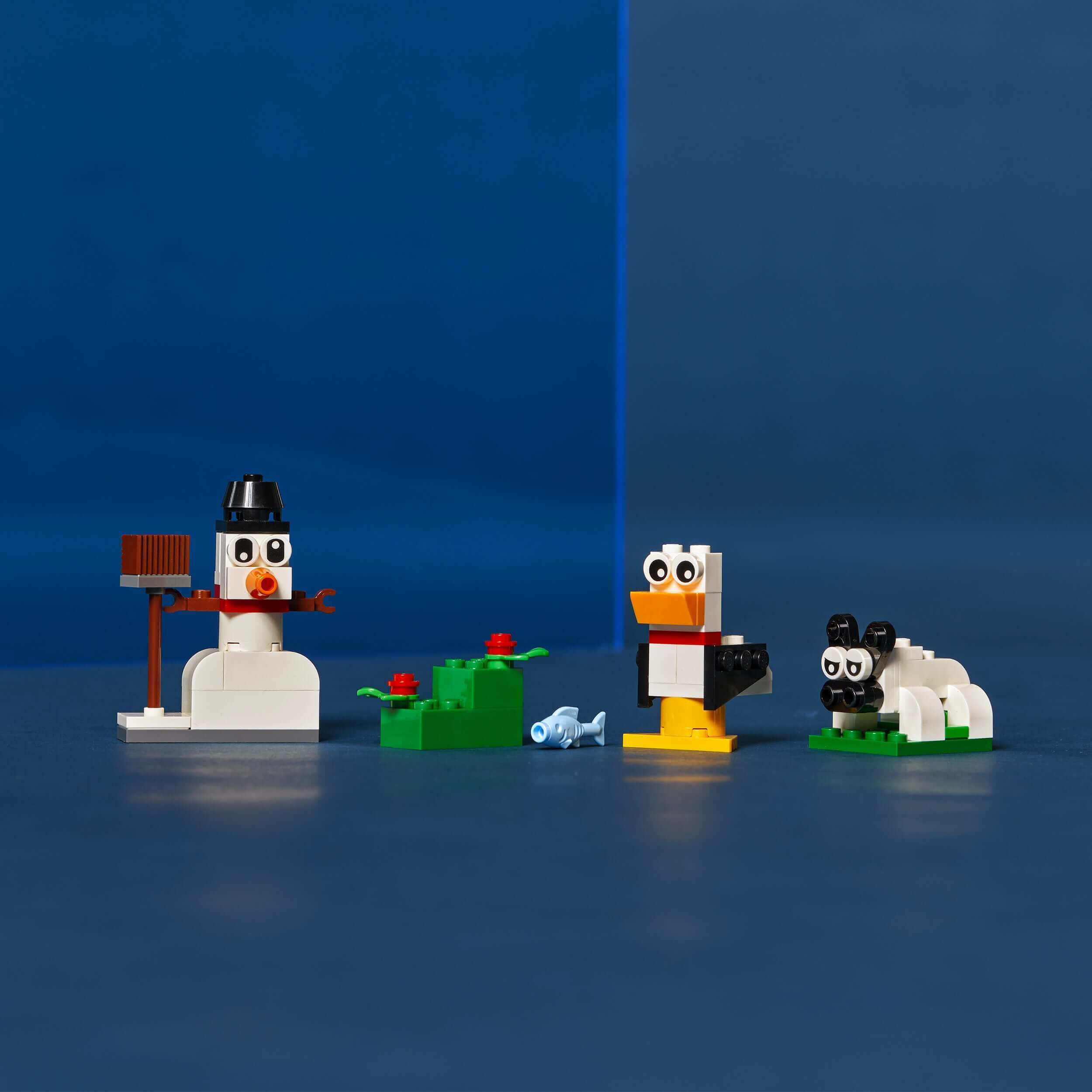LEGO Classic Creative White Bricks Set 11012 featuring a snowman, sheep, and seagull, perfect for creative building fun.