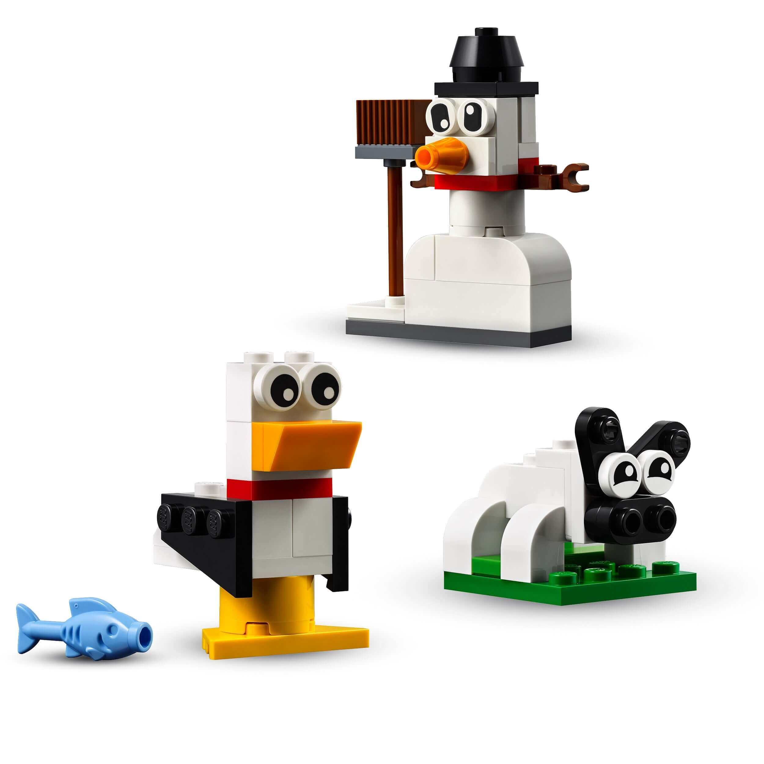 LEGO® Classic Creative White Bricks Set 11012 with a snowman, seagull, and sheep for imaginative building fun.