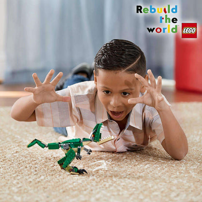 Child excitedly playing with LEGO® Creator 3in1 Mighty Dinosaurs T-Rex model on carpet, showcasing creativity and fun.