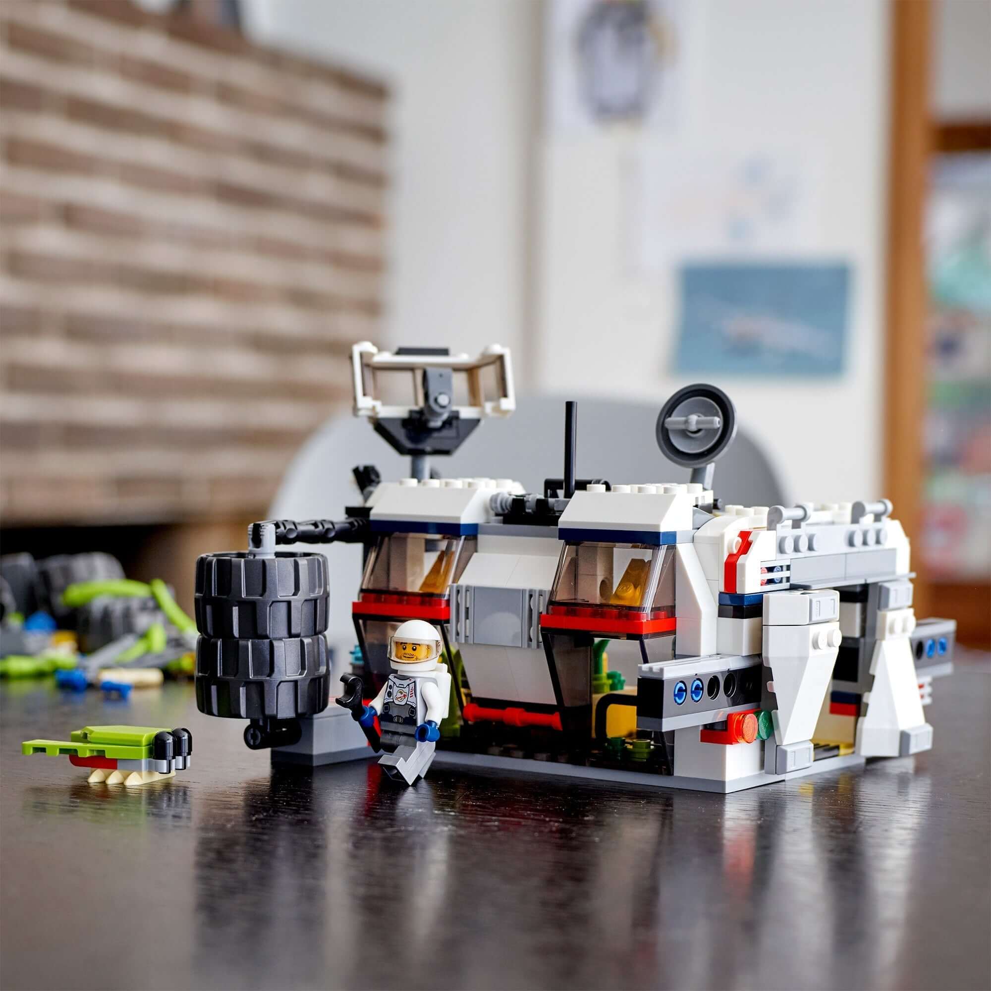 LEGO® Creator 3in1 Space Rover Explorer Set 31107 with astronaut figure and rover on a table, showcasing creative building.