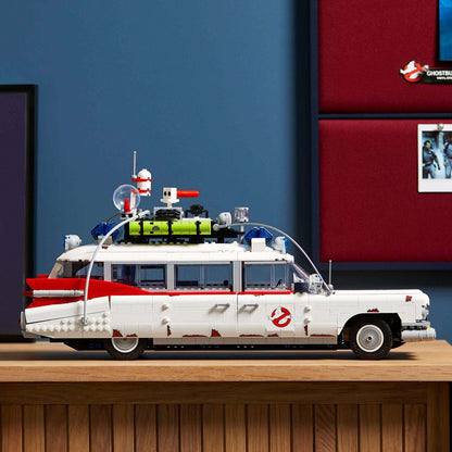 LEGO Creator Expert Ghostbusters ECTO-1 Set 10274 displayed on a wooden shelf against a blue wall.