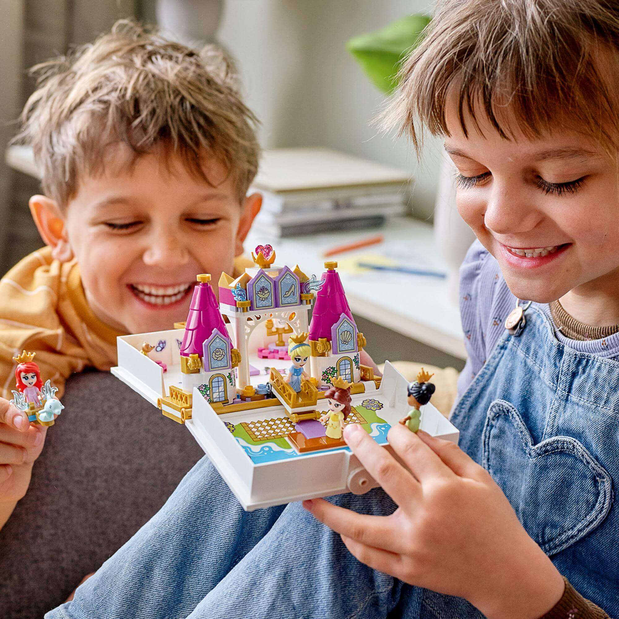 Children enjoying LEGO® Disney Princess Storybook Adventures playset with castle and micro-doll figures.