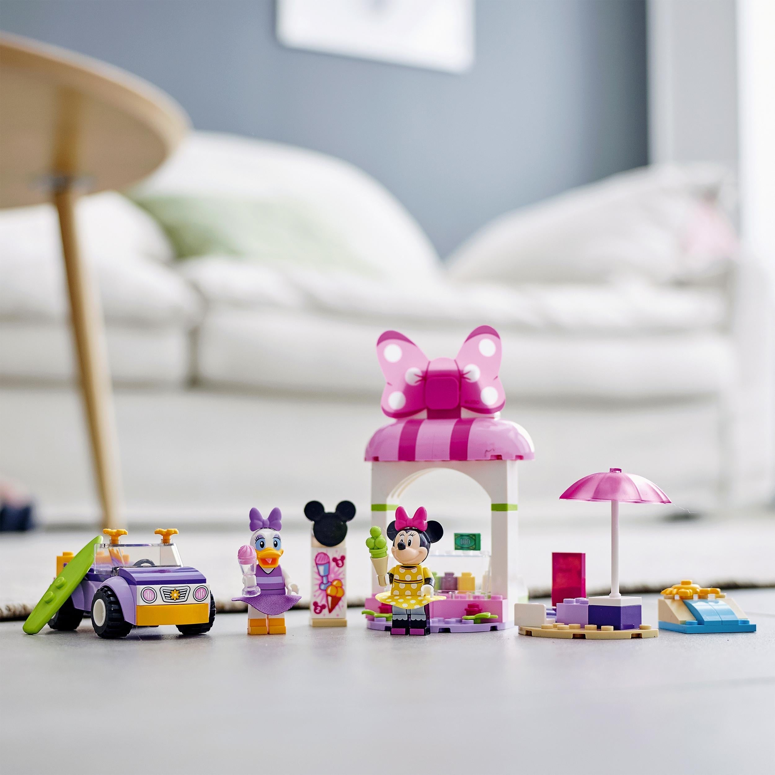 LEGO Disney Mickey Mouse Minnie Ice Cream Shop 10773 set with ice cream shop, car, and two minifigures in a playroom.